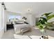Bright bedroom with a large window, contemporary lighting, and stylish neutral decor at 1242 Coach Station Aly # 101, Raleigh, NC 27601