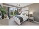Comfortable bedroom with a large window offering a lush outdoor view and neutral decor at 1242 Coach Station Aly # 101, Raleigh, NC 27601