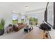 Sunlit living room featuring a comfortable sofa and a view of the outside at 1242 Coach Station Aly # 101, Raleigh, NC 27601