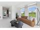 Cozy living room with large windows, comfortable seating, and scenic views at 1242 Coach Station Aly # 101, Raleigh, NC 27601