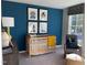 This bedroom features a navy accent wall, a crib and chair near a window at 128 Sagamore Avenue, Angier, NC 27501
