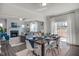 Modern dining area with wood table, white chairs, leading to the living room with a fireplace at 129 Sagamore Ave., Angier, NC 27501