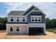 Charming two-story home with a two-car garage and light-grey and dark-blue siding at 129 Sagamore Avenue, Angier, NC 27501