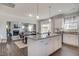Open-concept kitchen with granite island, white cabinets, flowing seamlessly into dining and living area at 129 Sagamore Ave., Angier, NC 27501