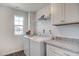 Efficient laundry room featuring side-by-side washer and dryer and granite countertops at 129 Sagamore Ave., Angier, NC 27501