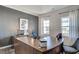 Bright office with wooden desk, grey accent wall, light curtains, and natural light from the windows at 129 Sagamore Ave., Angier, NC 27501