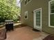 Backyard patio with a grill and exterior door leading to the house at 1307 Montreux Ct, Mebane, NC 27302