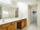 Bathroom features a double sink vanity with wood cabinets, large mirror, and access to the walk-in closet at 1307 Montreux Ct, Mebane, NC 27302