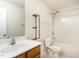 Cozy bathroom with a wood vanity, sink, toilet, and shower-tub combination at 1307 Montreux Ct, Mebane, NC 27302