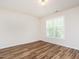 Bedroom featuring wood-look flooring and natural light at 1307 Montreux Ct, Mebane, NC 27302