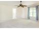 Spacious bedroom offering neutral carpet and a window with blue curtains, providing ample natural light at 1307 Montreux Ct, Mebane, NC 27302