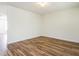Neutral bedroom with laminate floors, base molding and overhead light fixture providing a blank canvas for personal style at 1307 Montreux Ct, Mebane, NC 27302