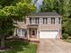 Charming two-story home with a well-manicured lawn, brick accents, and attached two-car garage at 1307 Montreux Ct, Mebane, NC 27302