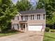 Charming two-story home with brick and vinyl siding and an attached two-car garage at 1307 Montreux Ct, Mebane, NC 27302