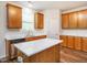 Bright kitchen featuring stainless steel appliances, ample wood cabinetry, a central island, and quartz countertops at 1307 Montreux Ct, Mebane, NC 27302