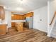 Charming kitchen with stainless steel appliances, ample cabinetry, a central island, and convenient access to the staircase at 1307 Montreux Ct, Mebane, NC 27302