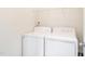 Laundry room featuring a modern white washing machine and dryer set at 1307 Montreux Ct, Mebane, NC 27302