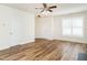 Large living room showcasing wood-look flooring and abundant natural light at 1307 Montreux Ct, Mebane, NC 27302