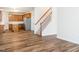 Bright living room featuring beautiful flooring, a staircase, and an open floor plan leading into the kitchen area at 1307 Montreux Ct, Mebane, NC 27302