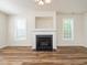 Cozy living room showcasing a fireplace, neutral walls, and stylish floors at 1307 Montreux Ct, Mebane, NC 27302