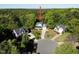 Aerial view of a gray house, nestled in a cul-de-sac, surrounded by lush green trees at 141 Clay Ridge Way, Holly Springs, NC 27540