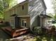 Rear exterior view showcasing the spacious deck, well-maintained yard, and attractive siding at 141 Clay Ridge Way, Holly Springs, NC 27540
