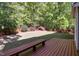Spacious backyard with a wooden deck and bench, perfect for outdoor entertaining at 141 Clay Ridge Way, Holly Springs, NC 27540