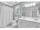 Inviting bathroom features a double sink vanity, large mirror and shower at 141 Clay Ridge Way, Holly Springs, NC 27540