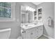 Bright bathroom features a double sink vanity, window and updated fixtures at 141 Clay Ridge Way, Holly Springs, NC 27540