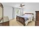 Bright bedroom with wood furniture and large window at 141 Clay Ridge Way, Holly Springs, NC 27540