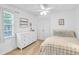 Comfortable bedroom with a ceiling fan, dresser, and bright window at 141 Clay Ridge Way, Holly Springs, NC 27540