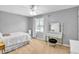 Well-lit bedroom featuring a vanity, ceiling fan, and neutral decor at 141 Clay Ridge Way, Holly Springs, NC 27540
