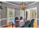 Chic dining room with dark table, colorful upholstered chairs, and wood floors at 141 Clay Ridge Way, Holly Springs, NC 27540