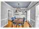 View of a dining room with wood floors, a chandelier, and a light gray walls at 141 Clay Ridge Way, Holly Springs, NC 27540