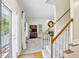 Home foyer with staircase, gray carpet, hardwood entry, and view of the living room at 141 Clay Ridge Way, Holly Springs, NC 27540