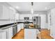 Updated kitchen with granite countertops, stainless steel appliances, and a center island at 141 Clay Ridge Way, Holly Springs, NC 27540