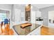 Open kitchen with stainless steel appliances, an island with granite countertops, and wooden floors at 141 Clay Ridge Way, Holly Springs, NC 27540