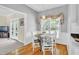 Bright kitchen nook with a glass table, wood floors and pendant lighting at 141 Clay Ridge Way, Holly Springs, NC 27540