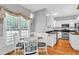 Bright kitchen nook with a glass table, wood floors and pendant lighting at 141 Clay Ridge Way, Holly Springs, NC 27540