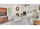 Bright living room featuring a fireplace, built-in cabinet and plush seating at 141 Clay Ridge Way, Holly Springs, NC 27540