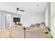 Comfortable living room with sectional sofa, TV, ceiling fan, and ample natural light at 141 Clay Ridge Way, Holly Springs, NC 27540