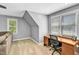 Cozy office space with a comfortable sofa, bright windows, and built-in desk at 141 Clay Ridge Way, Holly Springs, NC 27540