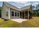 Exterior back porch with screened-in area, concrete patio, and verdant grassy backyard at 1412 Sagamore Dr, Louisburg, NC 27549