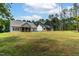 Backyard view of multiple homes featuring green grass and expansive lots in a community at 1412 Sagamore Dr, Louisburg, NC 27549