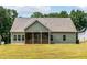 Exterior backyard featuring a screened-in porch, green grass, and an expansive lot at 1412 Sagamore Dr, Louisburg, NC 27549