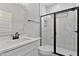 Well-lit bathroom features a marble-tiled walk-in shower and quartz vanity at 1412 Sagamore Dr, Louisburg, NC 27549