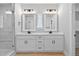The bright bathroom includes double sinks, white cabinets, and a glass shower at 1412 Sagamore Dr, Louisburg, NC 27549