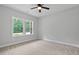 Neutral bedroom with a ceiling fan and natural light from the large window at 1412 Sagamore Dr, Louisburg, NC 27549
