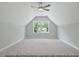The spacious bedroom features high ceilings, a ceiling fan, and a large window at 1412 Sagamore Dr, Louisburg, NC 27549
