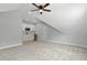 Bonus room with built-in cabinets, a wet bar, neutral walls, and a ceiling fan at 1412 Sagamore Dr, Louisburg, NC 27549